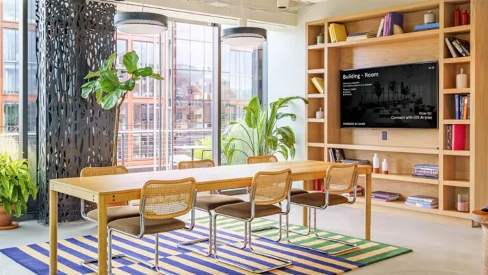 WeWork meeting room with a Mersive Solstice display showing room information and wireless sharing options